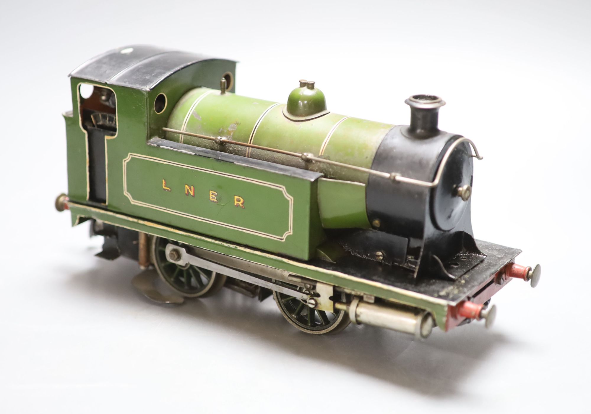 An early 20th century tinplate live steam loco converted to electricity, length 28cm